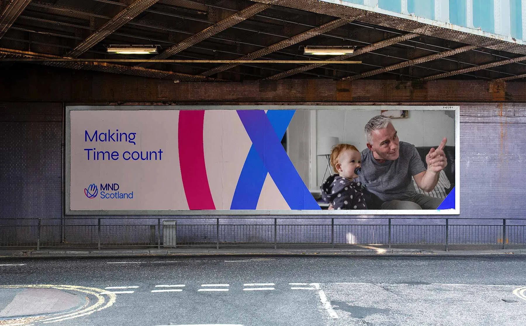 MND Scotland 'Making Time Count' billboard advert under a bridge