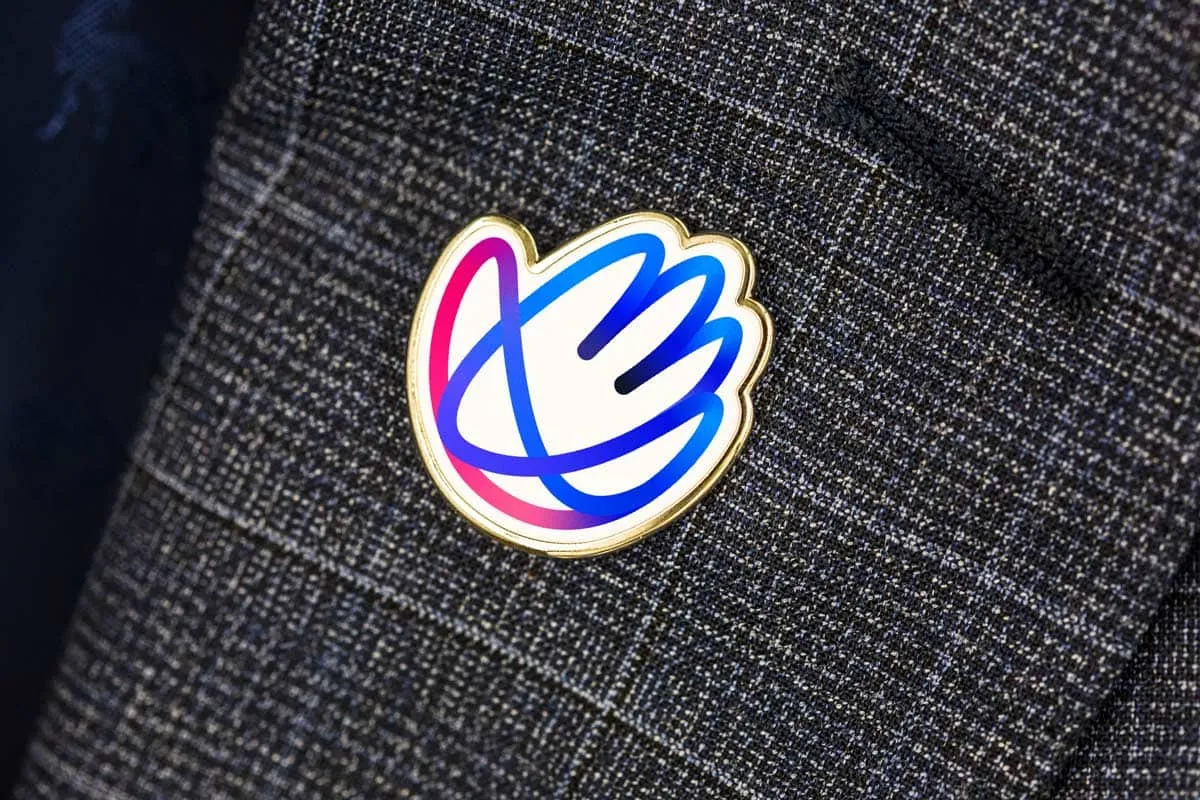 MND Scotland enamel pin badge on a jacket lapel