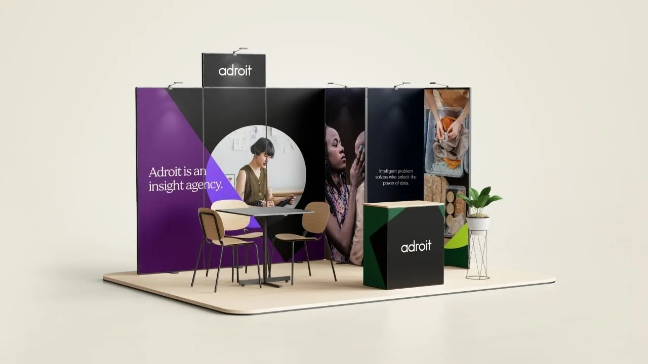 Adroit exhibition stand with branded signage and seating area