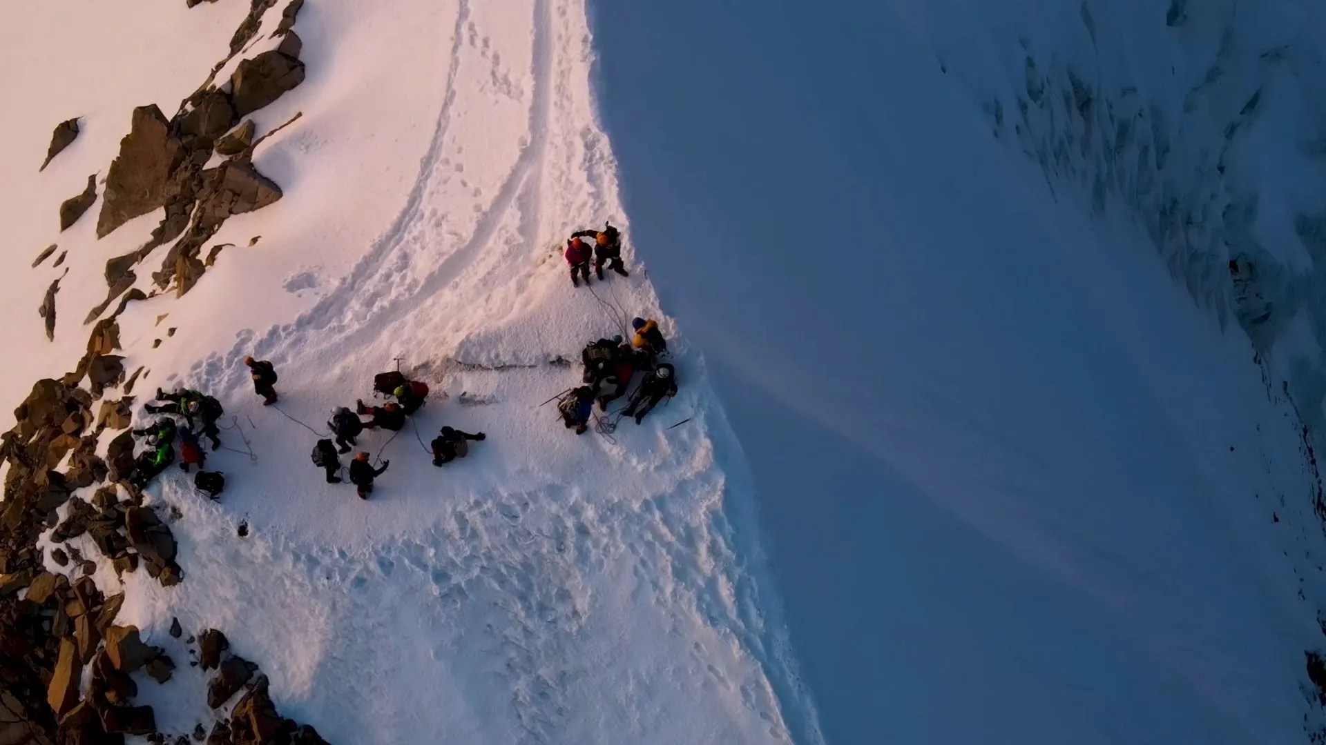 Aerial view of an expedition group on a snowy ridge
