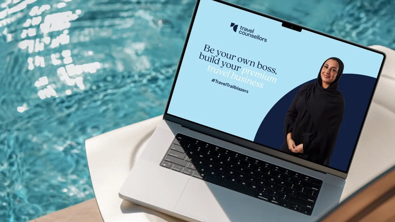 Laptop poolside showing the 'Be your own boss' Travel Counsellors microsite
