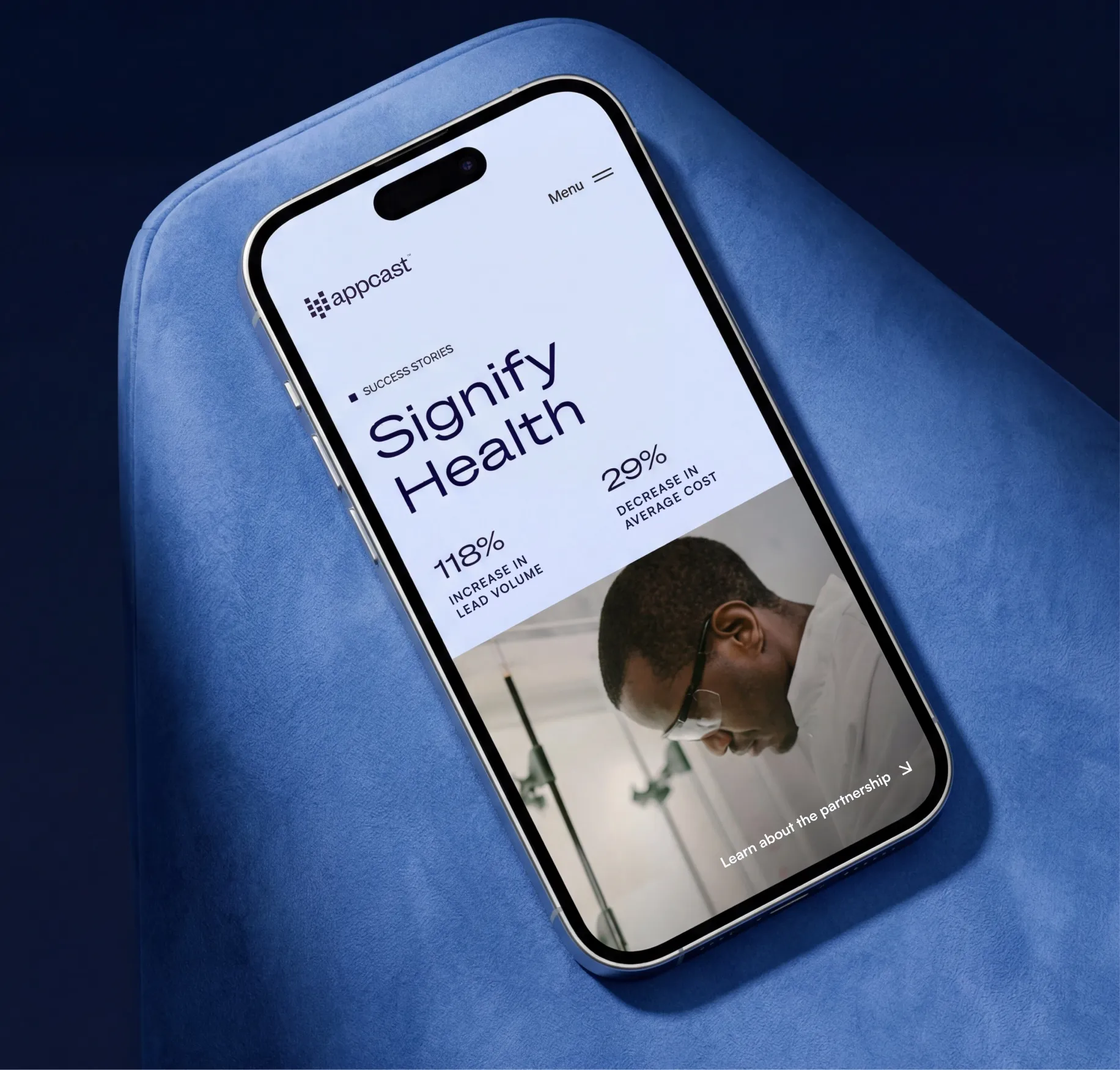 Signify Health success story on a phone lying on a blue sofa