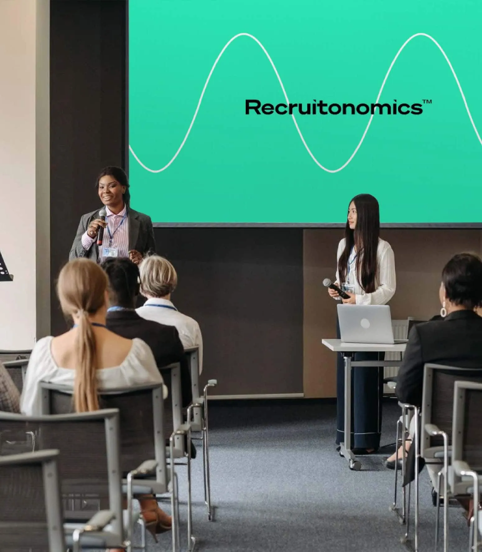 Andrew Flowers presenting Recruitonomics on stage at a conference