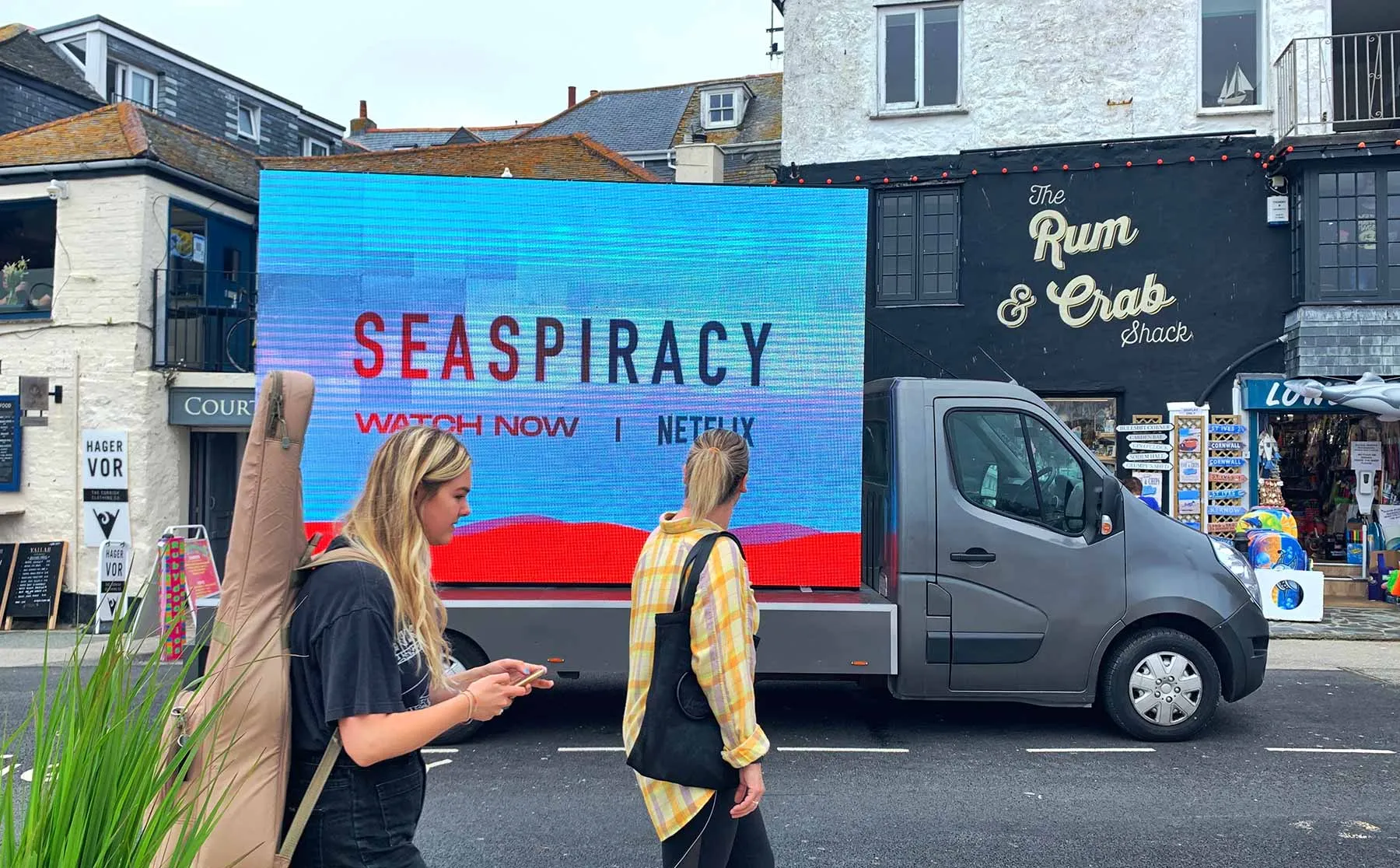 A mobile LED van displaying 'Seaspiracy, watch now on Netflix' on a Cornwall street